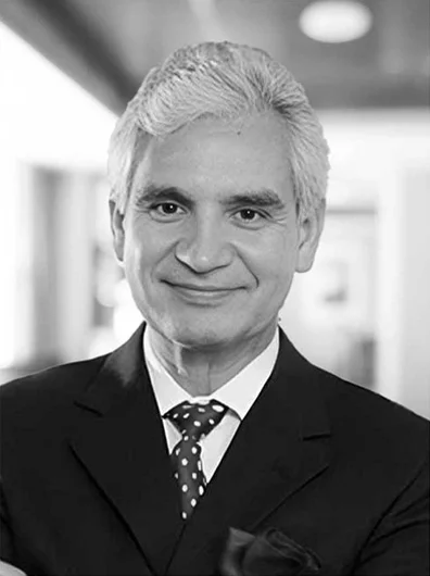Dr. Samaniego smiling with a suit and tie
