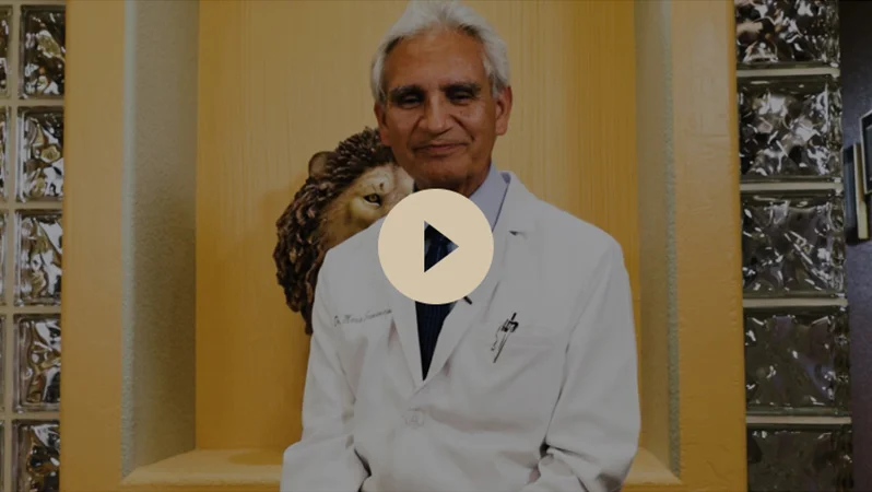 Dr. Samaniego smiling ready to talk with a play button overlay